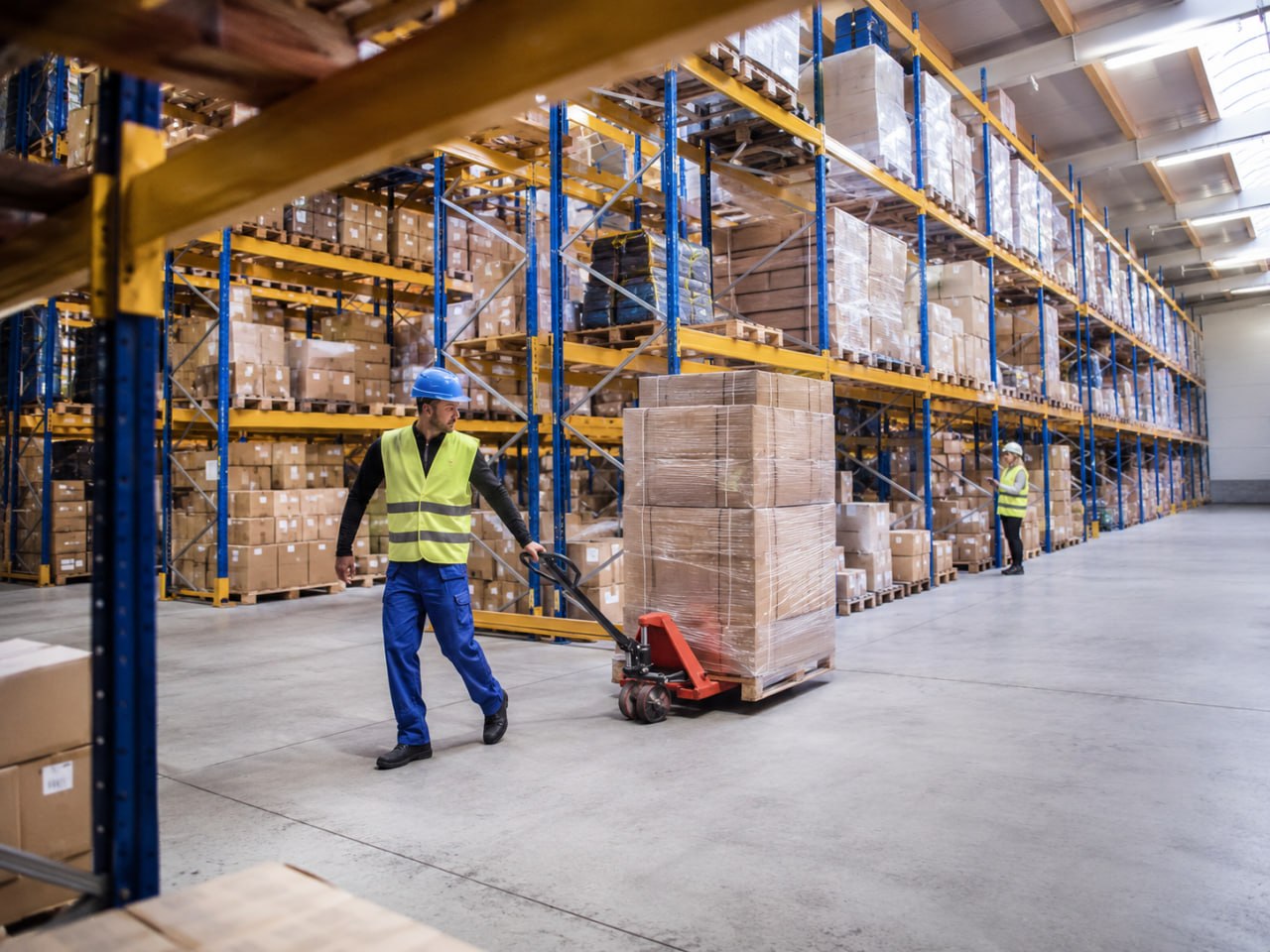 Local distribution warehouse with staged inventory and a worker scanning stock